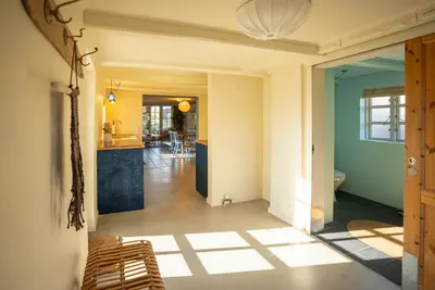 an open hallway with a kitchen and a living room at Historic Fisherman's Gem With Twist In Klitmøller in Torsted