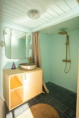 a bathroom with a sink and a mirror at Historic Fisherman's Gem With Twist In Klitmøller in Torsted