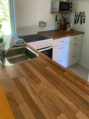 a kitchen with a sink and a stove at North Sea's Expanse Near Vorupør in Thisted