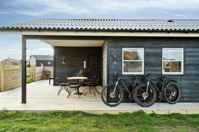 a group of bikes parked on a wooden deck at Minimalist Coziness By The Wild North Sea in Harboør