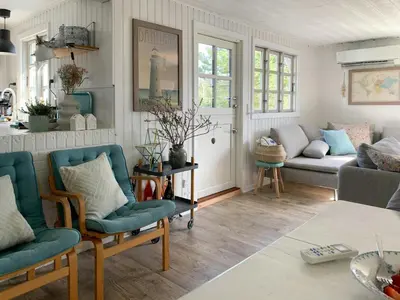 a living room with two chairs and a couch at Family House At Kryle Klit Near Wild Nature in Blokhus