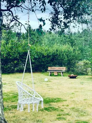 a swing in a yard with a park bench at Family House At Kryle Klit Near Wild Nature in Blokhus