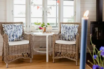 two wicker chairs and a table in a room at Grandma's House By Limfjord And Fur in Roslev