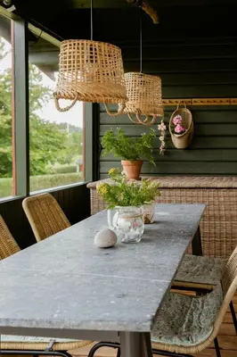 a table on a porch with two potted plants on it at Grandma's House By Limfjord And Fur in Roslev