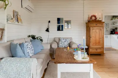a living room with a couch and a table at Grandma's House By Limfjord And Fur in Roslev
