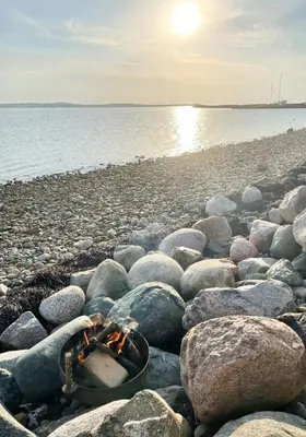 a group of rocks on a beach near the water at Historic House With Fjord View On Venø in Vemb