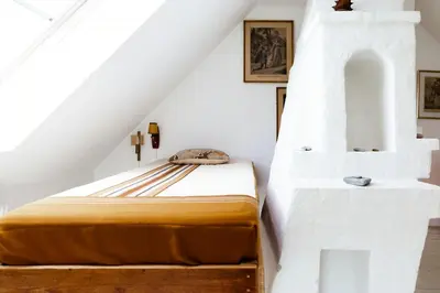 a bedroom with a bed in the attic at Magical Farm House Right Next To The Sea in Lemvig