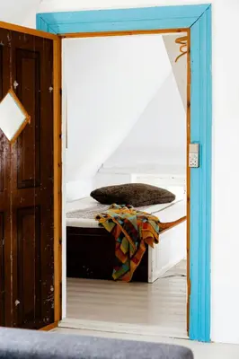 a mirror reflecting a bed in a room at Magical Farm House Right Next To The Sea in Lemvig