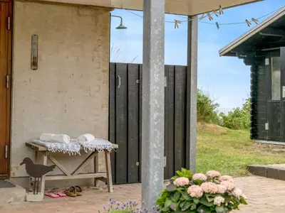 a table with towels on it next to a building at Holiday Home Bjerund - 300m from the sea by Interhome in Løkken