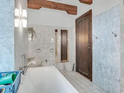 a bathroom with a tub and a toilet and a sink at Holiday Home Star - 200m to the fjord by Interhome in Farsø