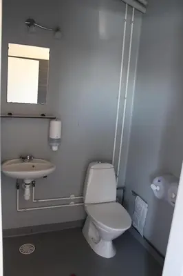 a bathroom with a toilet and a sink at Toftum Bjerge Camping & Cottages in Humlum