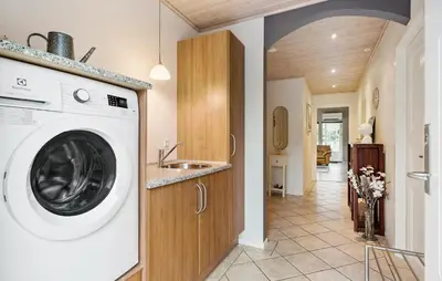a washing machine in a kitchen with a sink at Amazing Home In Højslev With Sauna in Højslev