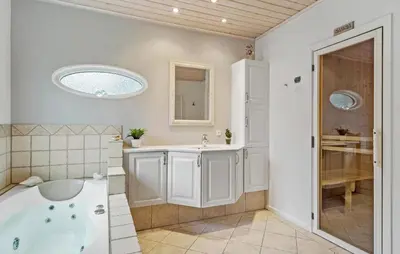 a bathroom with a tub and a sink at Amazing Home In Højslev With Sauna in Højslev