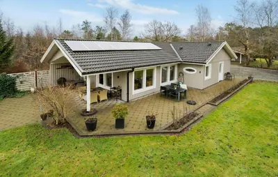 a house with a solar roof on a yard at Amazing Home In Højslev With Sauna in Højslev