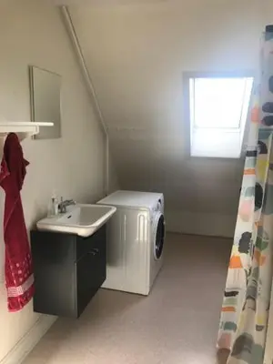 a bathroom with a sink and a washing machine at Svanegade 1 , 2 sal in Thyborøn
