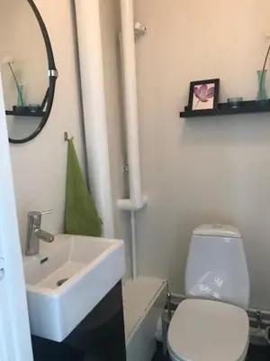 a bathroom with a white sink and a toilet at Svanegade 1 , 2 sal in Thyborøn