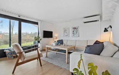 a living room with a white couch and a table at Amazing Home In Spøttrup With Wifi in Lihme