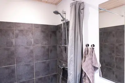 a bathroom with a shower with a shower curtain at Villa Holstebro in Holstebro