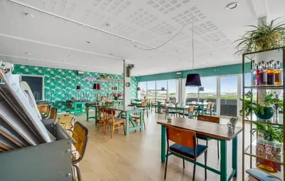 a restaurant with tables and chairs and windows at Gorgeous Home In Vestervig With Sauna in Vestervig