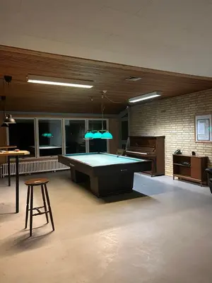 a large room with a pool table in it at Hostel Mors in Erslev
