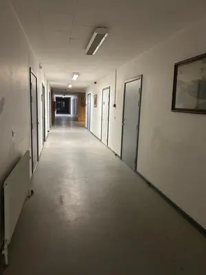 an empty hallway of an office building with doors and a hallwayngth at Hostel Mors in Erslev