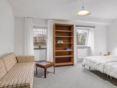 a bedroom with a bed and a book shelf at Holiday Home Eva - 9km to the fjord by Interhome in Brovst