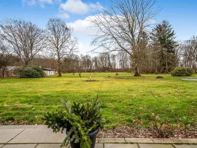a grassy field with a park with trees at Holiday Home Eva - 9km to the fjord by Interhome in Brovst