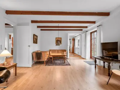 a living room with a table and a couch at Holiday Home Eva - 9km to the fjord by Interhome in Brovst