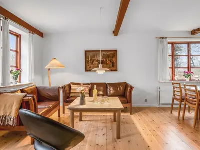 a living room with a couch and a table at Holiday Home Eva - 9km to the fjord by Interhome in Brovst