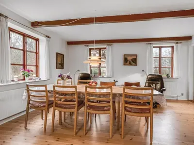 a dining room with a table and chairs at Holiday Home Eva - 9km to the fjord by Interhome in Brovst