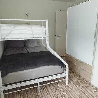a white bunk bed in a small room at Hyggelig lejlighed i stille by in Vemb