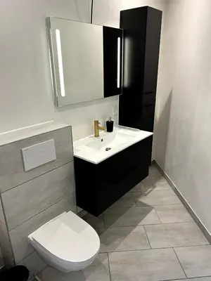 a bathroom with a white sink and a toilet at Cozy Newly Renovated Apartment in Nørager