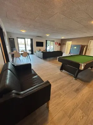 a living room with a pool table and couches at Cozy Newly Renovated Apartment in Nørager