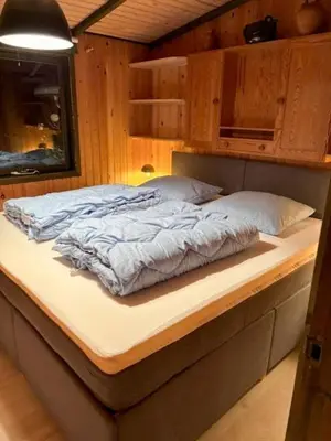 a bed sitting on a counter in a room at Charming Wooden Summer House In Trend in Løgstør