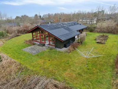 an overhead view of a small house with solar panels on it at Charming Wooden Summer House In Trend in Løgstør