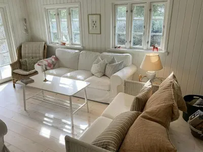 a living room with a couch and a table at Relaxed Summer House By The North Sea in Blokhus