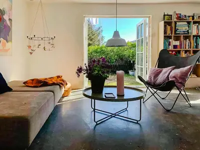 a living room with a couch and a table and a window at In Cold Hawaii With Beach In Backyard in Torsted