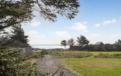 a gravel path leading to the water with trees at Cozy Home In Vestervig With Sauna in Vestervig