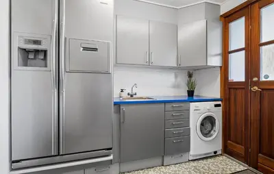 a kitchen with a refrigerator and a washing machine at Beautiful Home In Nibe With Sauna in Nibe