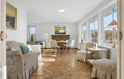 a living room with a couch and a table with chairs at Beautiful Home In Nibe With Sauna in Nibe