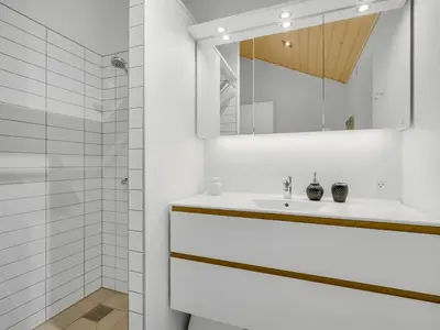 a white bathroom with a sink and a mirror at Holiday Home Nico - 70m to the inlet by Interhome in Roslev