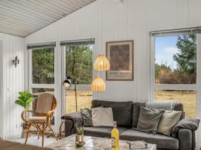 a living room with a couch and a table at Holiday Home Hansa - 3km from the sea by Interhome in Blokhus