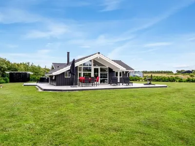 a house with a large yard with green grass at Holiday Home Antero - 500m to the fjord by Interhome in Spottrup