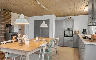 a kitchen with a wooden table and chairs in a kitchen at Nice Home In Vinderup With Wifi in Vinderup