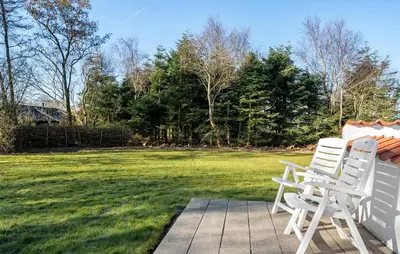 two white chairs sitting on a porch with a yard at Nice Home In Vinderup With Wifi in Vinderup