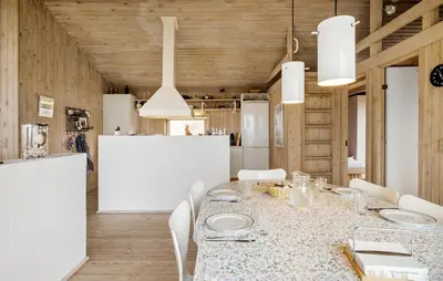 a dining room with a table and white chairs at Cozy Home In Saltum With House Sea View in Saltum