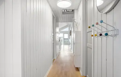 a hallway with white walls and wooden floors at 3 Bedroom Amazing Home In Spøttrup in Spottrup