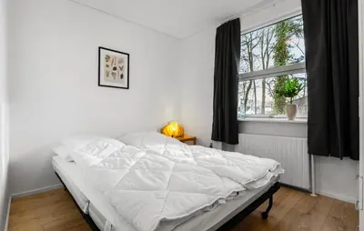a white bed in a bedroom with a window at 3 Bedroom Cozy Home In Farsø in Farsø