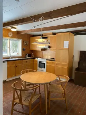 a kitchen with a table and chairs in a room at Unique location in Thy in Thisted