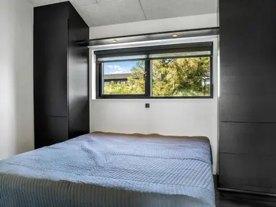 a bedroom with a bed and a window at Holiday Home Eriksine - 750m from the sea by Interhome in Løkken